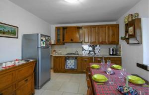 a kitchen with a table and a refrigerator at Awesome Home In Valpromaro With Wifi in Valpromaro