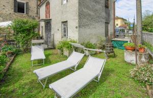 a group of chairs and tables in a yard at Awesome Home In Valpromaro With Wifi in Valpromaro
