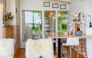a kitchen with a table and chairs in a room at Lakehouse Reeuwijk in Reeuwijk
