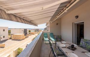 a patio with a table and chairs on a balcony at 3 Bedroom Lovely Apartment In Mandre in Mandre