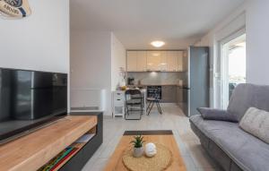 a living room with a couch and a table at 3 Bedroom Lovely Apartment In Mandre in Mandre