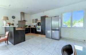 a large kitchen with a stainless steel refrigerator at 3 Bedroom Gorgeous Home In Garrigues in Garrigues