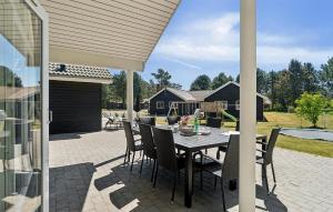 Un patio con una mesa y sillas en un patio. en Pet Friendly Home In Nexø With Kitchen, en Neksø
