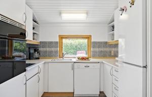 a white kitchen with a sink and a window at Cozy Home In Slagelse With Wifi in Slagelse