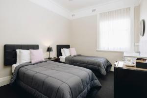 Postel nebo postele na pokoji v ubytování Hotel Gosford