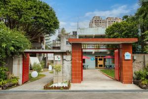 an orange building with a gate in front of it at 1954 Guest House in Taipei
