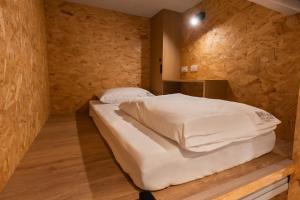 a bedroom with a bed in a stone wall at 1954 Guest House in Taipei