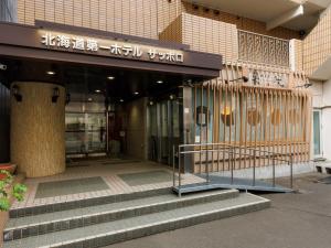a building with stairs in front of a store at Tabist Hokkaido Daiichi Hotel Sapporo in Sapporo +41 photos