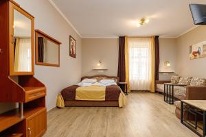 Postel nebo postele na pokoji v ubytování Готель Кайзер у Львові