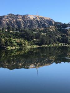 a reflection of a hill in a body of water at Universal Studios-Hollywood Hills guest suite with King bed in Los Angeles