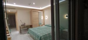 a bedroom with a green bed and a mirror at AIR-IN Rooms with magnificent views in Spata
