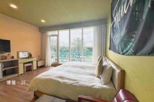 a bedroom with a large bed and a large window at The Riverview Retreats in Wujie
