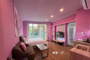 a purple bedroom with a bed and a couch at The Riverview Retreats in Wujie