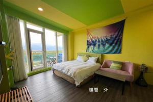 a bedroom with a bed and a chair and a painting at The Riverview Retreats in Wujie +51 photos