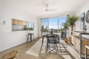 a kitchen with a table and chairs in a room at 2 Bedroom Coastal getaway with ocean views! in Port Macquarie