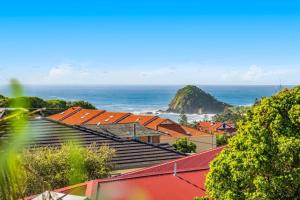 a group of buildings with the ocean in the background at 2 Bedroom Coastal getaway with ocean views! in Port Macquarie