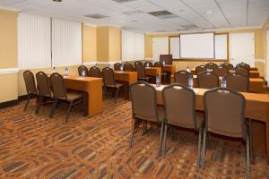a conference room with tables and chairs in it at American Inn of Bethesda in Bethesda