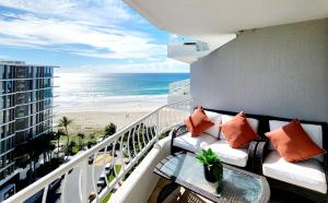 a balcony with a couch and a view of the beach at 19th Avenue on the Beach in Gold Coast