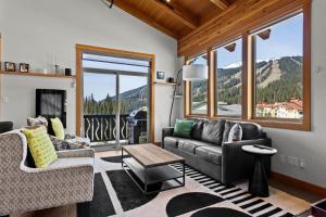 a living room with a couch and a table at Kookaburra Lodge #401 By Bear Country in Sun Peaks