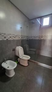 a bathroom with a toilet and a sink at Belle maison de campagne in Kenitra +9 photos