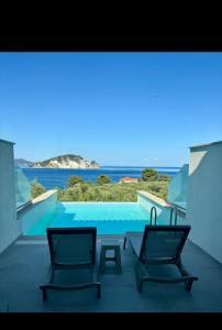 two chairs on a balcony with a view of the ocean at Lente vivus in Marathias
