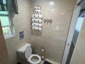 a bathroom with a toilet and a pile of towels at Gold Star in Plant City