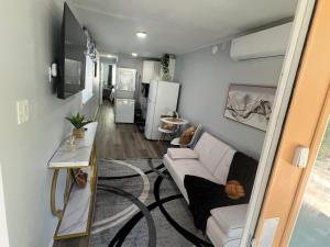 a living room with a couch and a refrigerator at Gold Star in Plant City