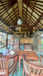 comedor con mesa de madera y sillas en Wina Ubud B&B, en Ubud