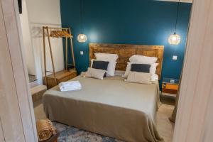 a bedroom with a large bed with blue walls at La Bastide du Mûrier in Cotignac
