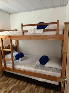 two bunk beds in a room with blue towels on them at Alojamiento Villasofia in Armenia
