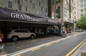 a white car parked in front of a clothing store at Adlige Hotel in Seoul