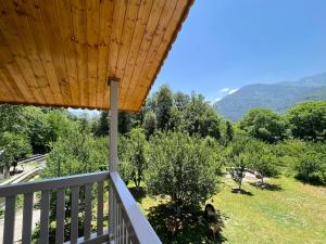 a view from the balcony of a house with trees at Somvan Chalet by Mick-Hans in Baragrān