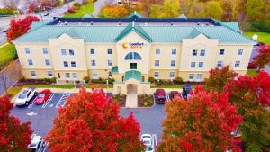 an aerial view of a building with a parking lot at Comfort Suites East Brunswick - South River in East Brunswick