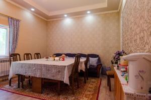 a dining room with a table and some chairs at ilim-mahabat in Bishkek