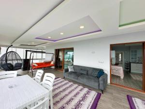 a living room with a couch and a table at İma Deluxe Villa in Trabzon