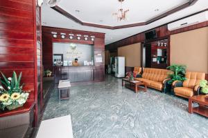 a lobby with a waiting room with orange furniture at V Hotel Vientiane in Vientiane
