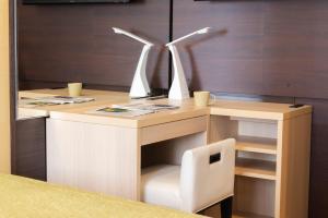 a desk with a chair and a computer with two wind turbines at Shinjuku Washington Hotel Annex in Tokyo