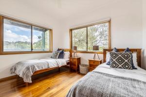 a bedroom with two beds and two windows at VAQUAY The Orchard In Tootgarook in Tootgarook