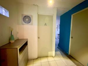 a room with a hallway with a door and a table at Suites Brisa Marina - Playa Regatas y Malecón in Veracruz