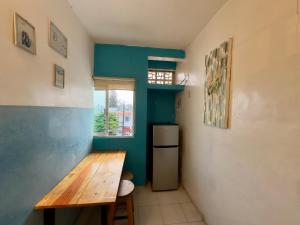 a kitchen with a wooden table and a refrigerator at Suites Brisa Marina - Playa Regatas y Malecón in Veracruz