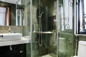 a bathroom with a sink and a glass shower at Studio apartment in Hoan Kiem in Hanoi