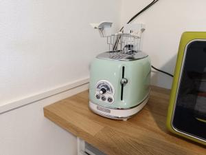a toaster sitting on top of a wooden table at Gente di Mare Holiday House in Marina di Pisa