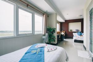 a hospital room with two beds and two windows at V Hotel Vientiane in Vientiane