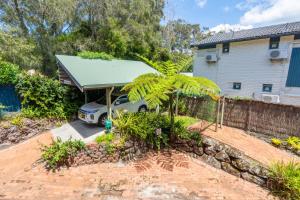 a house with a car parked in the driveway at Surfers Rest in Byron Bay