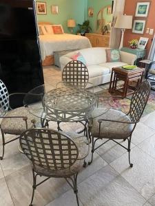 sala de estar con mesa de cristal y sillas en Estero Beach and Tennis PH5 Building C condo, en Fort Myers Beach