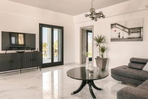 a living room with a table and a couch at The Ionian Sea & Sunset View Villa in Minia