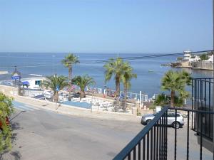 a view of a beach with palm trees and the ocean at Maremaris B&B in Trani