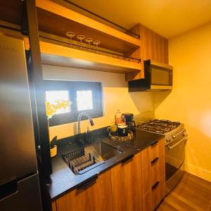 a kitchen with a sink and a stove at Vacation Condo 1 bedroom in Tijuana