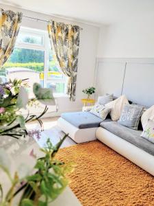 a living room with a couch and a rug at 'Serenity in Somerset' , Scenic Views across Dorset , Half a mile from Devon & Close to the Jurassic Coast without the Hustle & Bustle in Chardstock