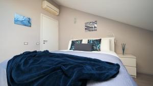 a bedroom with a bed with a laptop on it at Blu Note Apartment in Turin